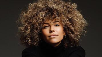 A woman with curly hair and a black turtle neck photo