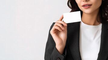 A woman in a business suit holding a blank card photo