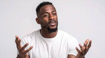 A man with a beard and white shirt is talking photo