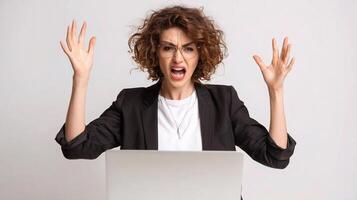 A woman with her hands up and a laptop photo
