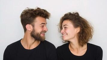 A man and woman are smiling and looking at each other photo