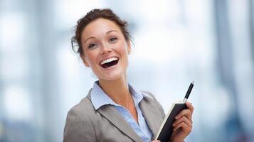 A smiling business woman holding a pen and notepad photo
