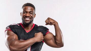 A man in a football uniform flexing his muscles photo
