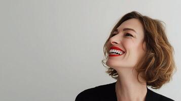 A woman with red lipstick smiling photo
