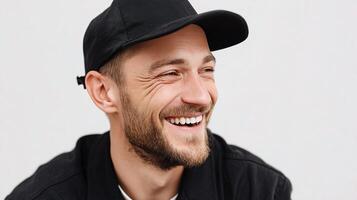 A man with a beard and a black hat smiling photo