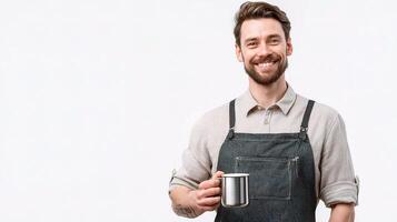 A man in an apron holding a cup photo