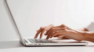 A person typing on a laptop computer photo