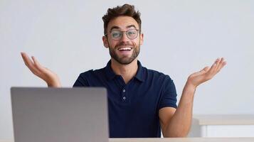 A man with glasses and a laptop is sitting at his desk photo