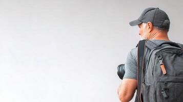 A man with a backpack and a hat photo