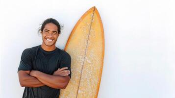 A man is smiling with his surfboard photo