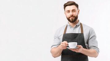 A bearded man in an apron holding a cup of coffee photo