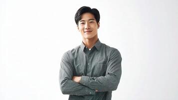 A young man in a gray shirt standing with his arms crossed photo