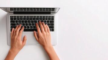 Top view of hands typing on a laptop photo
