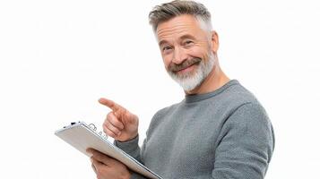 A man with a beard and gray sweater holding a clipboard photo