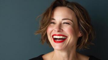 A woman with short hair and red lipstick smiling photo
