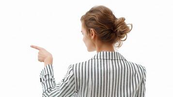 A woman in a striped shirt pointing at something photo