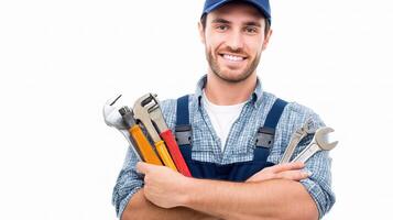 A man in overalls holding a wrench and tools photo