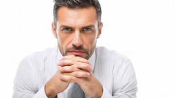 A man in a white shirt and tie sitting with his hands on his chin photo