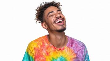 A man with a tie dye shirt laughing photo