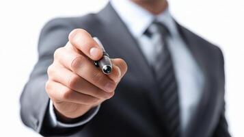 A man in a suit is pointing to a pen photo