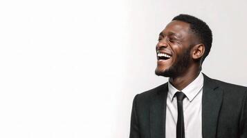 A man in a suit and tie laughing photo