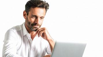 A man in a white shirt is looking at his laptop photo