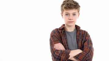 A boy with his arms crossed standing in front of a white background photo