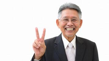 An older man in a suit and tie showing a peace sign photo