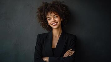 A beautiful young woman with curly hair in a black suit photo
