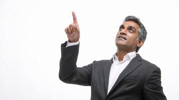 A man in a suit pointing up photo