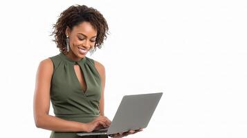 A woman in a green dress is using a laptop photo