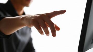 A person pointing at a computer monitor photo