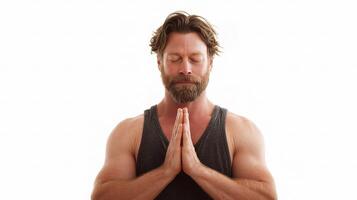 A man with a beard and a tank top is meditating photo