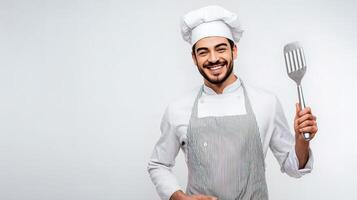 A man in a chef hat holding a spatula photo