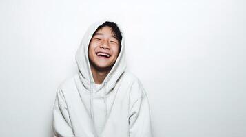 A young man in a white hoodie laughing photo