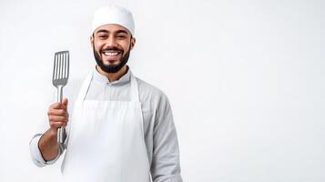 A smiling man in a chef's hat holding a fork photo