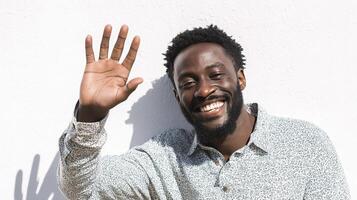 A man with a beard and a smile is waving photo