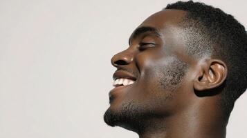 A man smiling with his head tilted to the side photo