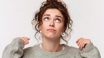 A woman is looking up with her hands on her head photo