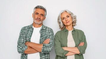 An older couple standing together against a white background photo
