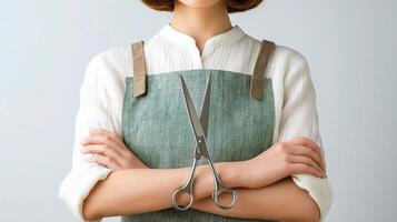 A woman in an apron holding scissors photo