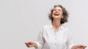 A woman laughing and smiling on a white background photo