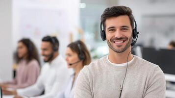 A smiling man in a call center with his colleagues photo