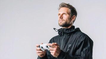 A man in a black jacket holding a controller photo