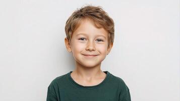 A young boy is smiling and posing for the camera photo