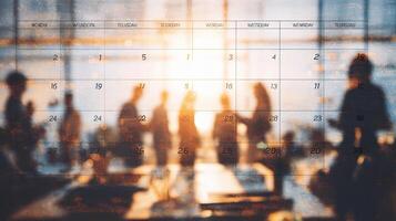 A calendar with people standing in front of it photo
