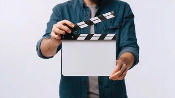 A man holding a clapper board with a blank screen photo
