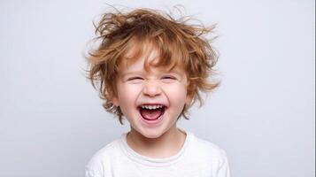 A young boy with his mouth open and hair flying photo