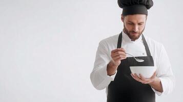 A man in a chef hat is holding a bowl of food photo