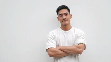 Asian man standing with arms crossed against white background photo